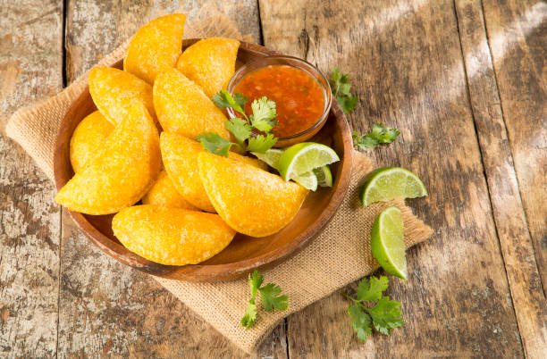 Colombian empanada with spicy sauce stock photo