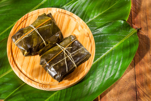 Colombian Tamale recipe with steamed banana leaves stock photo