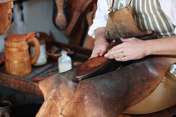 Colonial shoemaker in Williamsburg, Va Shoemaker in Colonial Williamsburg, Va. williamsburg virginia stock pictures, royalty-free photos & images