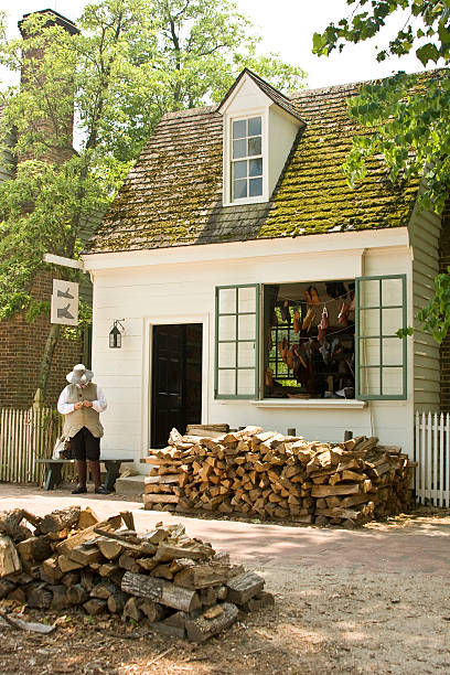 Colonial shoeshop Shoemaker is outside his shoeshop waiting for business in Colonial Williamsburg, Virginia williamsburg virginia stock pictures, royalty-free photos & images