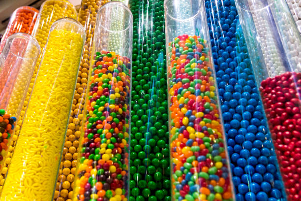 Color Candy Jellybeans Gumballs in Clear Plastic Towers These collections of jellybeans, gumballs, and other candies are for sale in a toystore.  This very colorful display used clear acrylic tubes to hold all the candy. candy store stock pictures, royalty-free photos & images