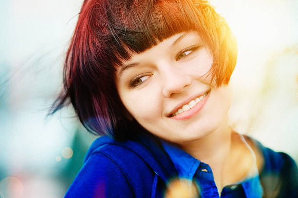 Color portrait of a charming and laughing girl Color portrait of a charming and laughing girl bangs hair stock pictures, royalty-free photos & images