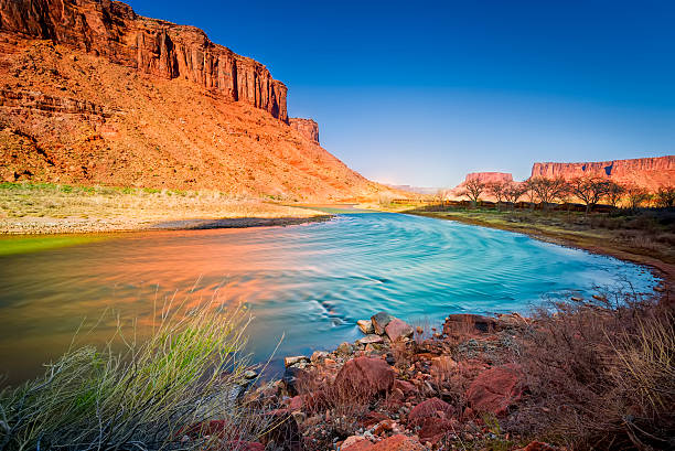 Colorado River in Utah Late afternoon long exposure view of a colorful bend in the colorado River outside Moab, UT colorado river stock pictures, royalty-free photos & images