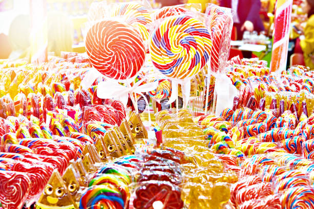 Colored caramel lollipops in shop Colored caramel lollipops in a pastry shop candy store stock pictures, royalty-free photos & images