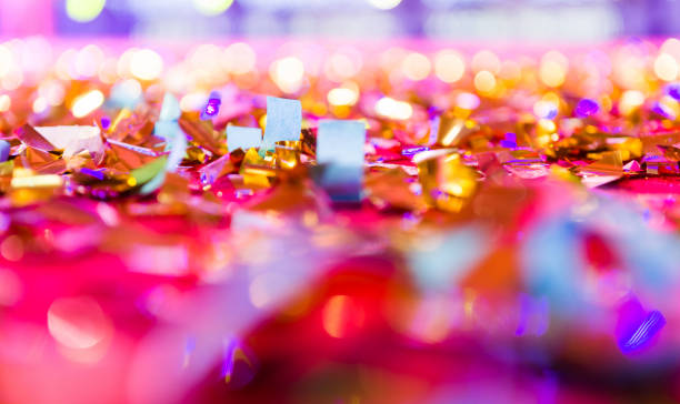 Colored confetti falling on floor stock photo