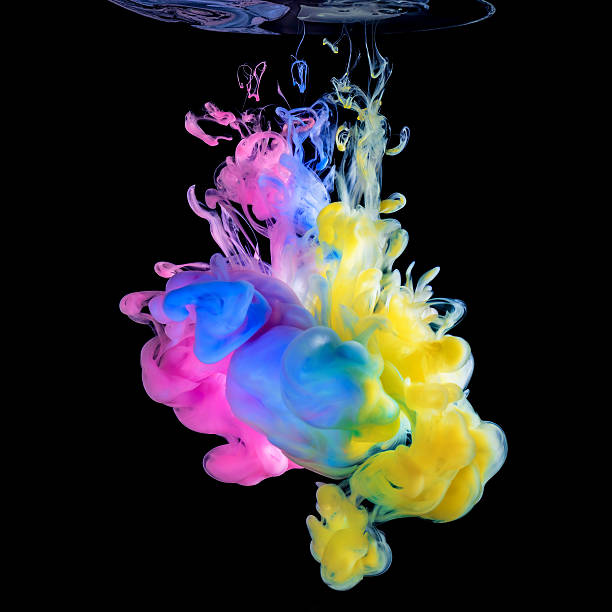 Photo of Colored inks in water on black background