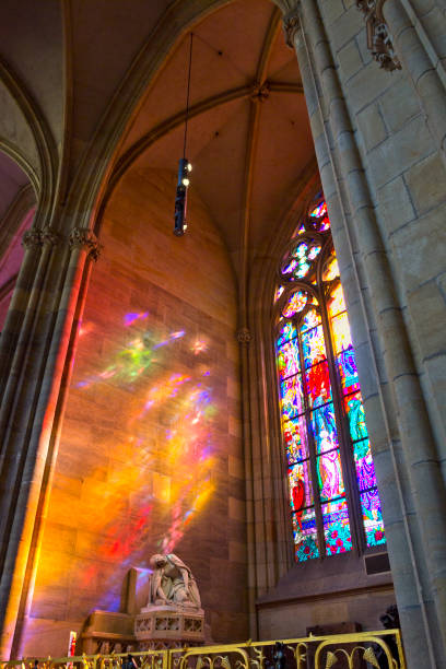 Colored lights reflecting from stained-glass window in St. Vitus Cathedral, Prague, Czech Republic Interior of St. Vitus Cathedral in Prague, Czech Republic, with colored lights reflecting from stained-glass window. The church is a place of worship. prague art stock pictures, royalty-free photos & images