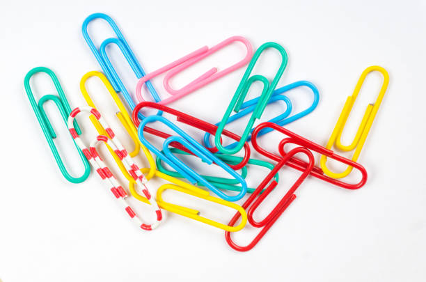 colored paper clips on white background stock photo