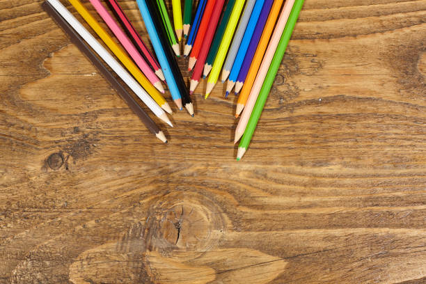 colored pencils on wooden table. stock photo