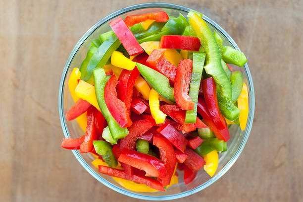 Colored peppers mixed in a bowl Colored peppers mixed in a glass bowl chopped food stock pictures, royalty-free photos & images