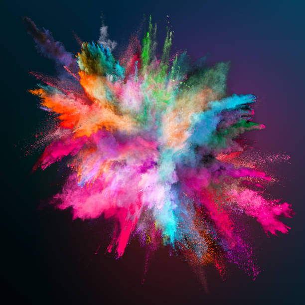 Colored powder explosion on dark gradient background. stock photo