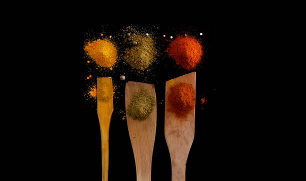 Colored spoons with spices stock photo