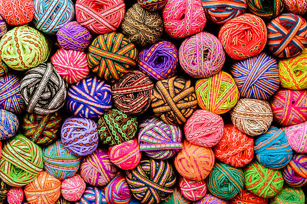 A large variety of colorful balls of yarns and ribbons  in market in Cusco, Peru.