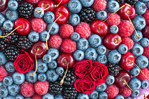 Colorful background made of different berries and flowers