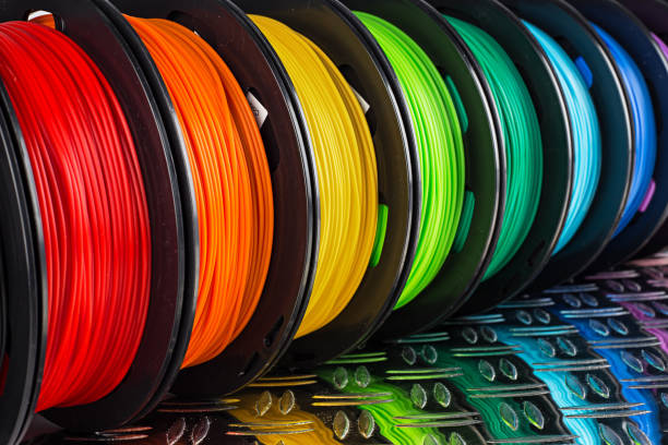 colorful bright  row of spool 3d printer filament black metal background colorful bright row of spool 3d printer pla abs filament plastic material on dark black metal steel diamond plate background light bulb filament stock pictures, royalty-free photos & images