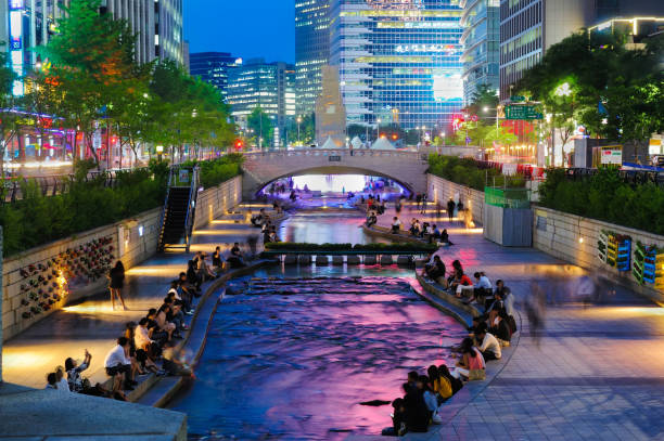 Colorful city lights of Cheonggyecheon Stream Park with Crowd at night in Seoul City, South Korea. stock photo