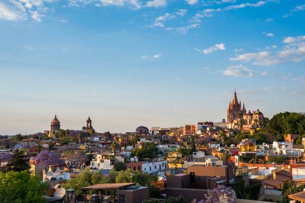 Colorful cityscape of San Miguel de Allende in Mexico, a Spanish colonial town, featuring Parroquia de San Miguel Arcángel, a beautiful church in the Spanish baroque architectural style stock photo