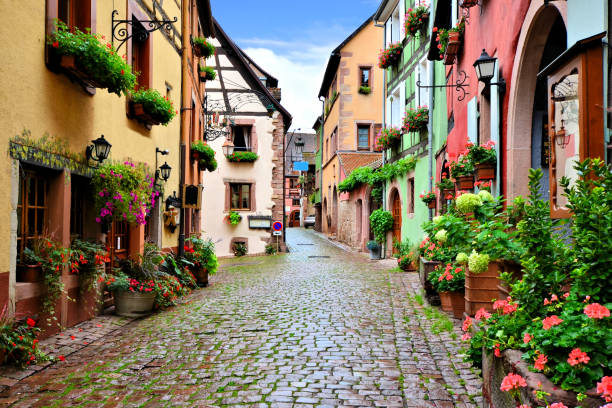 Colorful cobblestone lane in the Alsatian town of Riquewihr, France stock photo