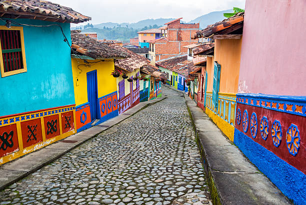 Colorful Cobblestone Street Colorful colonial houses on a cobblestone street in Guatape, Antioquia in Colombia colombia stock pictures, royalty-free photos & images