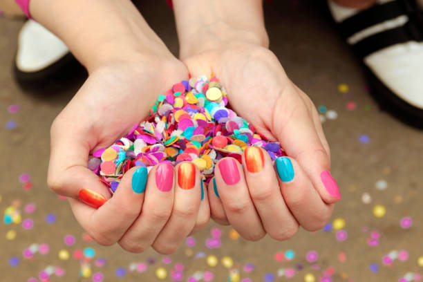 Colorful colorful manicure with confetti stock photo
