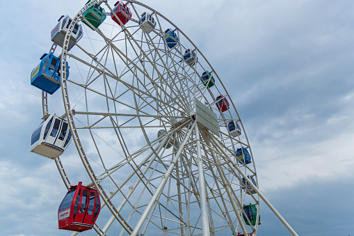 Kazakhstan Almaty August 24, 2016: Colorful Ferris wheel against blue sky, blue sky, ferris wheel