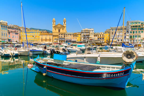 BASTIA PORT, CORSICA ISLAND - JUL 4, 2015: colorful fishing boat in Bastia harbour on sunny summer day, Corsica island, France. Fishing and yacht boats anchoring in Bastia port in summer season. This port connects Corsica with Italy and France mainland. bastia stock pictures, royalty-free photos & images