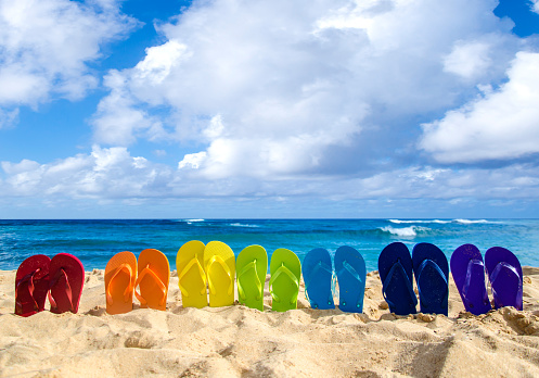 Colorful Flip Flops On The Sandy Beach Stock Photo - Download Image Now - iStock
