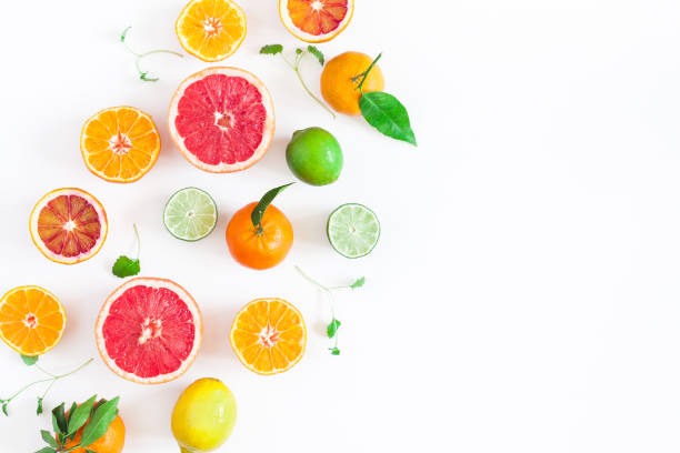 Colorful fresh fruits on white table. Flat lay, top view Fruit background. Colorful fresh fruits on white table. Orange, tangerine, lime, lemon, grapefruit. Flat lay, top view, copy space citrus fruit stock pictures, royalty-free photos & images
