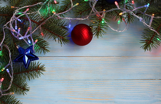Colorful garland on spruce branches