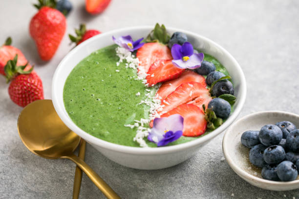Colorful, healthy food. Acai green smoothie bowl. Keto breakfast idea. Colorful, healthy food. Acai green smoothie bowl. Keto breakfast idea. Matcha Yoghurt  stock pictures, royalty-free photos & images