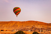 istock Colorful hot air balloon flying over Valley of The Kings in the morning. 1391220115