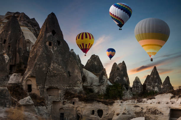 Colorful hot air balloons flying over Cappadocia in the morning Colorful hot air balloons flying over Cappadocia in the morning rock hoodoo stock pictures, royalty-free photos & images