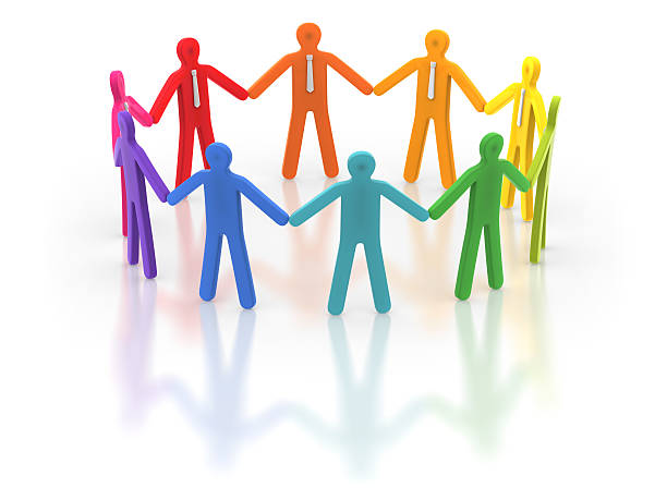 Colorful human figures holding hands in a circle stock photo