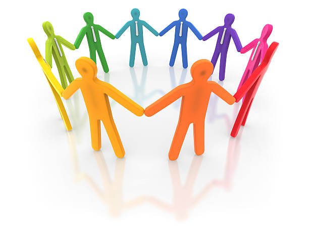 Colorful human figures holding hands in a circle stock photo