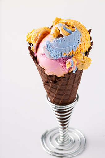 Colorful cotton candy ice cream in waffle cone