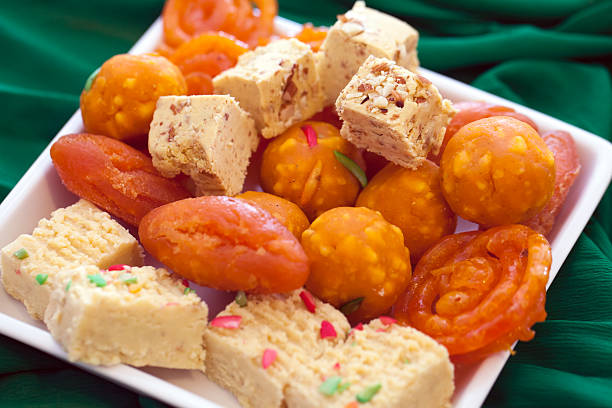Colorful Indian Diwali  sweets in plain white dish Colorful Indian Diwali  sweets in plain white dish mithai stock pictures, royalty-free photos & images