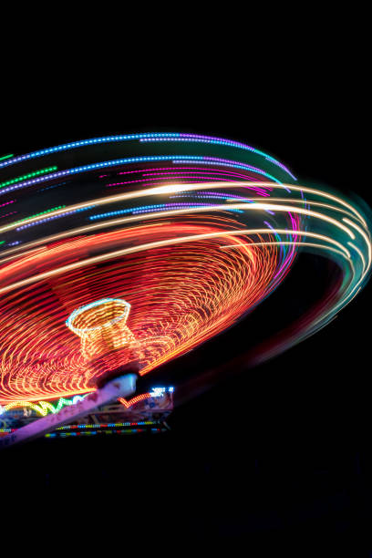 Colorful Light Trail From A Fast Carrousel At A Fun Park In The NIght stock photo