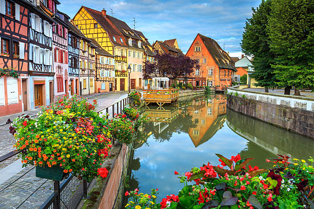 Colorful medieval half-timbered facades reflecting in water,Colmar,France Spectacular colorful traditional french houses on the side of river Lauch in Petite Venise,Colmar,France,Europe alsace stock pictures, royalty-free photos & images