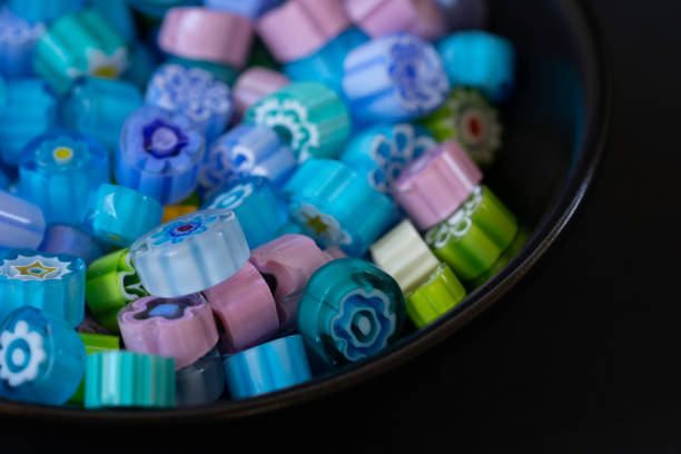 Colorful Millefiori Glass Beads in a Black Bowl stock photo