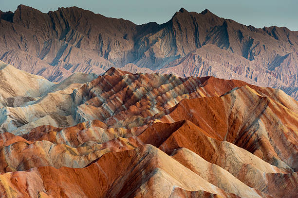 Colorful mountain in Danxia landform in Zhangye, Gansu of China The Danxia landform (Chinese: 丹霞地貌; pinyin: dānxiá dìmào) refers to various landscapes found in southeast and southwest China that "consist of a red bed characterized by steep cliffs". It is a unique type of petrographic geomorphology found in China. Danxia landform is formed from red-coloured sandstones and conglomerates of largely Cretaceous age. The landforms look very much like karst topography that forms in areas underlain by limestones, but since the rocks that form danxia are sandstones and conglomerates, they have been called "pseudo-karst" landforms danxia landform stock pictures, royalty-free photos & images