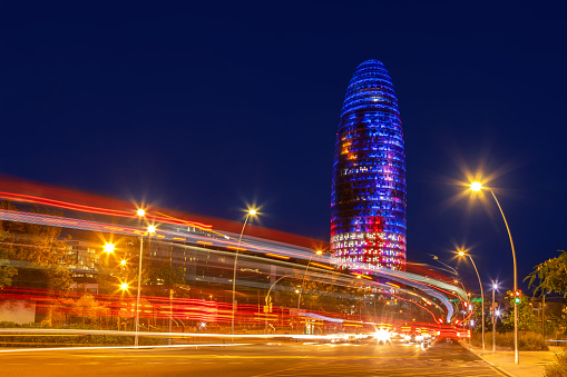 Colorful night view of the Glorias Tower in Barcelona
