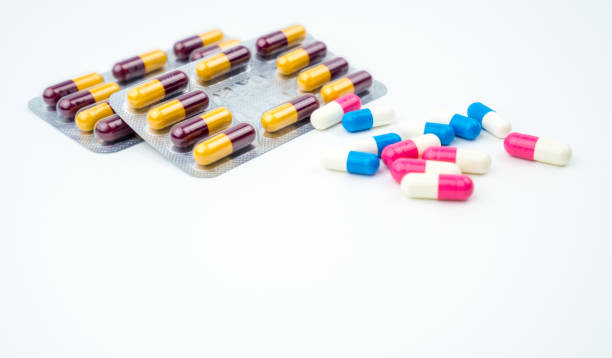 Colorful of antibiotic capsules pills on white background with copy space. Drug resistance, antibiotic drug use with reasonable, health policy and health insurance concept. Colorful of antibiotic capsules pills on white background with copy space. Drug resistance, antibiotic drug use with reasonable, health policy and health insurance concept. pics for amoxicillin stock pictures, royalty-free photos & images
