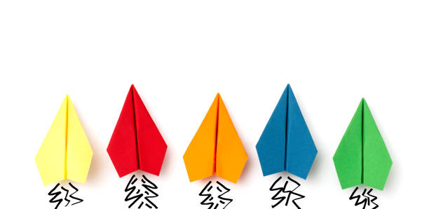 Colorful paper planes in a row on white background with painted starting effect.