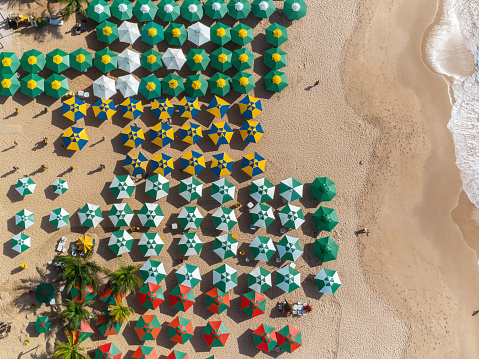 drone view on colorful parasols at beach in Bahia, Brazil