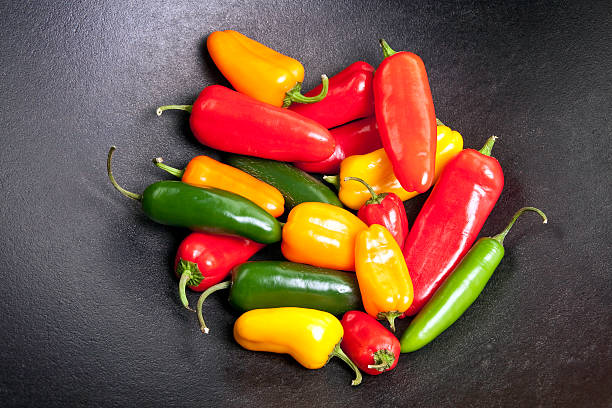 Colorful Peppers in a Cast Iron Pot stock photo
