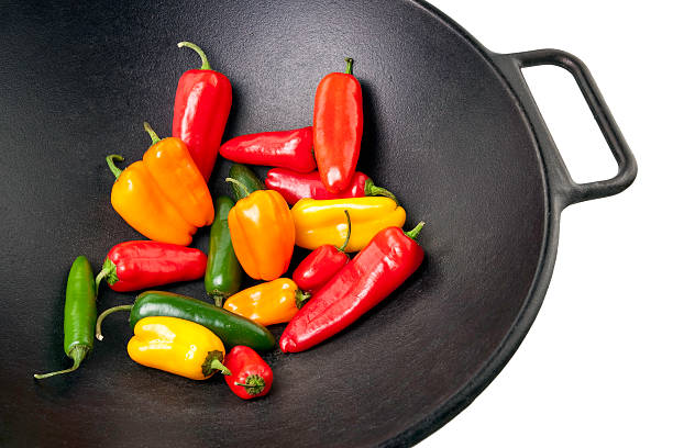 Colorful Peppers in Cast Iron Wok stock photo