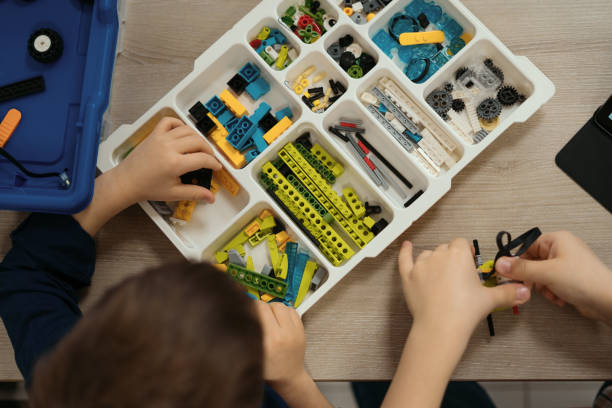 Colorful pieces from building kit for children on table stock photo