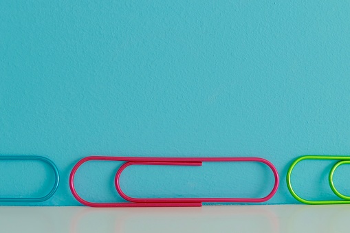 Colorful row of clips on blue background