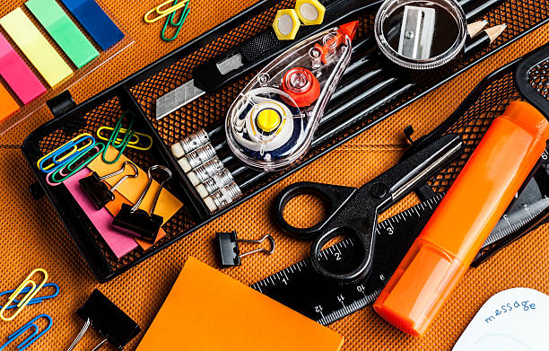 colorful school and office supplies colorful school and office supplies on an orange background office equipment stock pictures, royalty-free photos & images