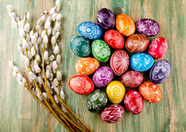 colorful scratched handmade Easter eggs on a wooden table stock photo